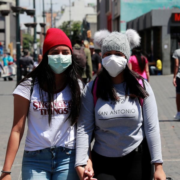 Women wearing protective masks during COVID-19 coronavirus global spread pandemic early 2020