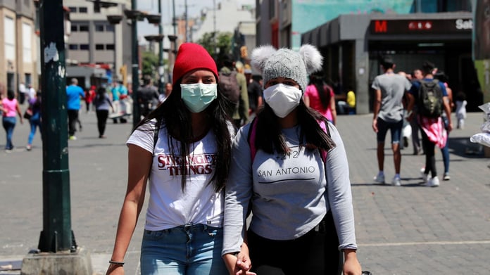 Women wearing protective masks during COVID-19 coronavirus global spread pandemic early 2020