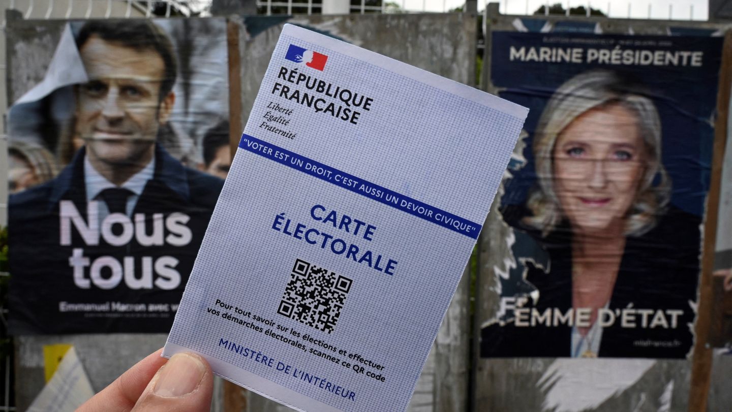 Electoral campaign posters for France municipal elections with Macron and Le Pen campaign boards