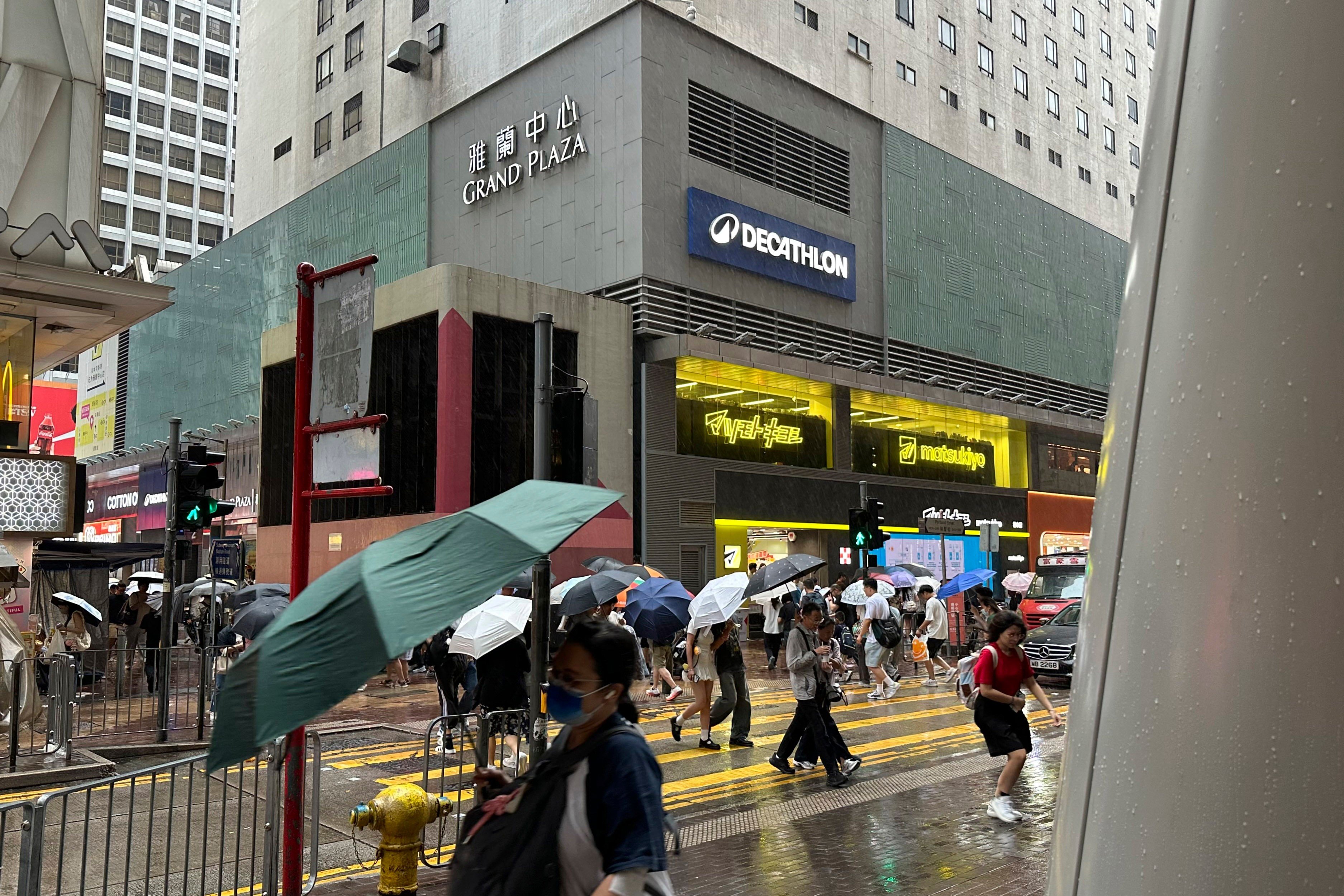 Pedestrians walk through Hong Kong Mong Kok district where the toilet paper robbery occurred in February 2020
