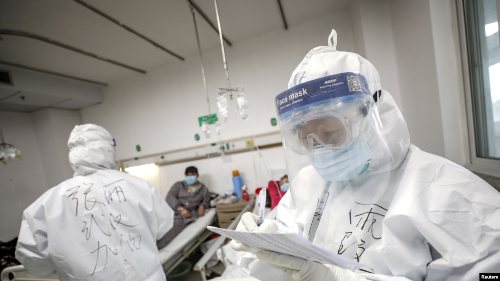 A medical worker in protective equipment checking patient records at Jinyintan hospital in Wuhan China during the early COVID-19 outbreak