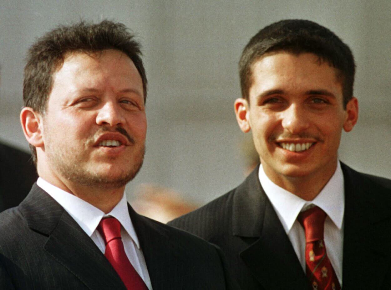 Jordan's King Abdullah (L) and his brother Crown Prince Hamzah share a joke before the arrival of [..