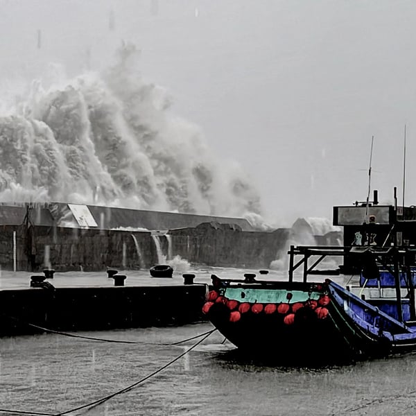 A wave crashing over a sea wall as Super Typhoon Kong-rey neared the coast in Taitung