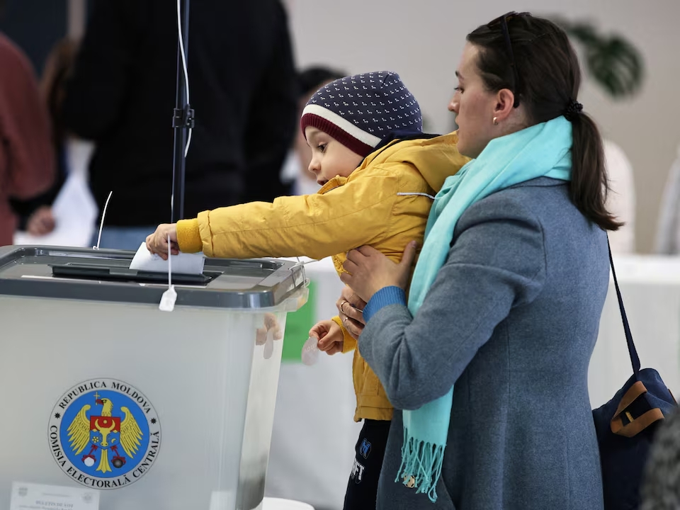candidate casts her ballot at a polling station