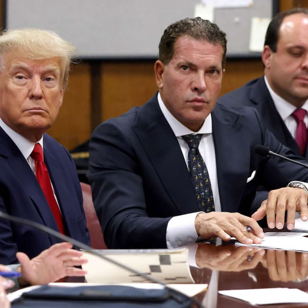 President Donald Trump sits with his attorneys Joe Tacopina and Boris Epshteyn