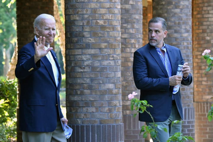 US President Joe Biden (L) waves alongside his son Hunter Biden