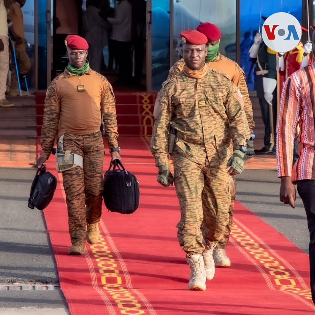 Ibrahim Traore walking a red carpet in uniform with his escort in 2023