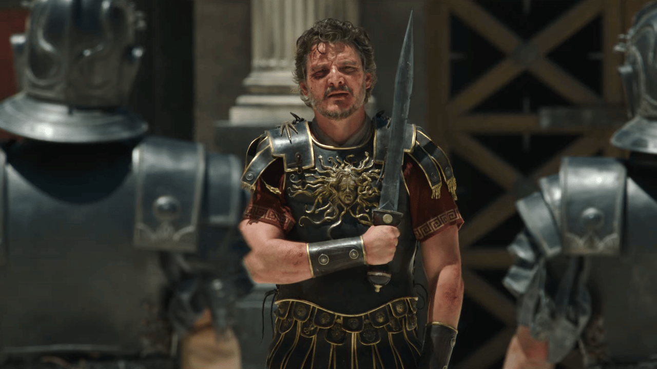 Pedro Pascal in gladiator gear, hands clenched on a sword pedro pascal roman general costume