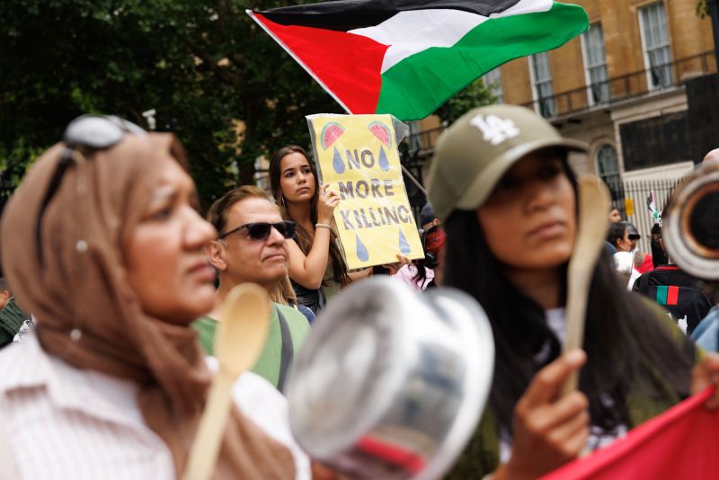 Palestinians gather at an aid distribution point amid ongoing Israeli airstrikes, Gaza City