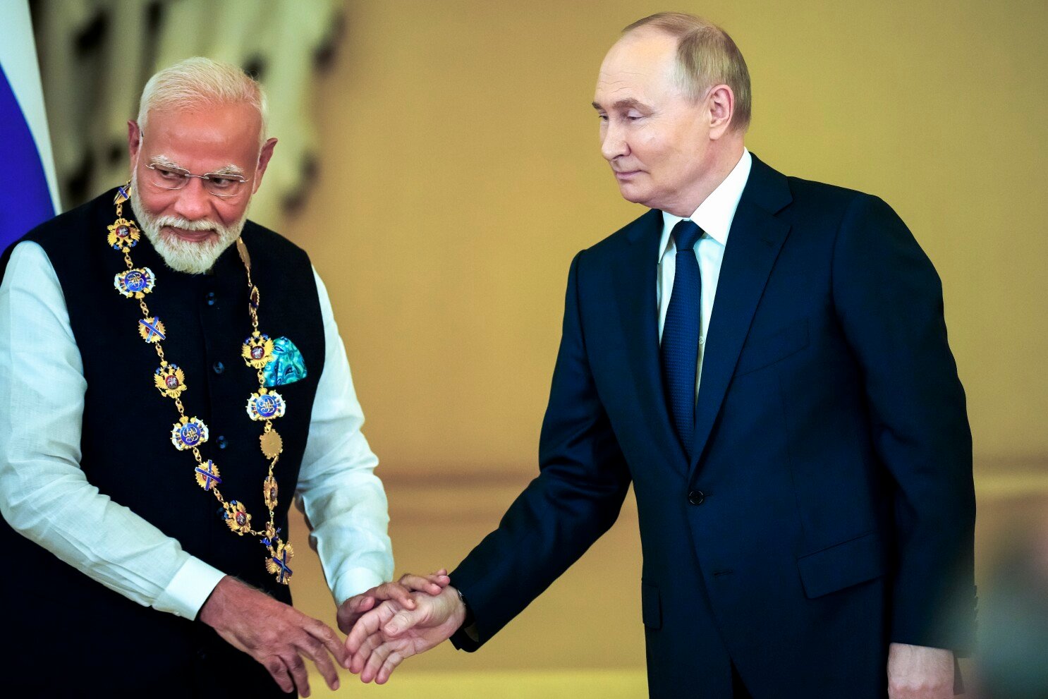 Vladimir Putin and Narendra Modi shaking hands during high-level meeting in Moscow