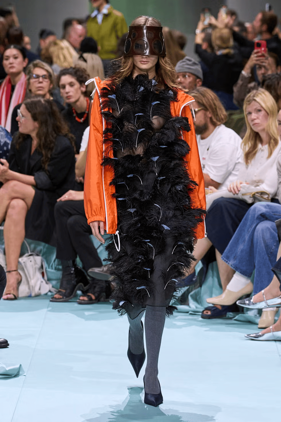 Burberry SS26 waxed parka layered over a mini dress at Kensington Gardens