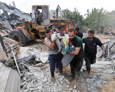Rescuers search the ruins of a family home in Az-Zawayda after an Israeli airstrike killed 11, including children