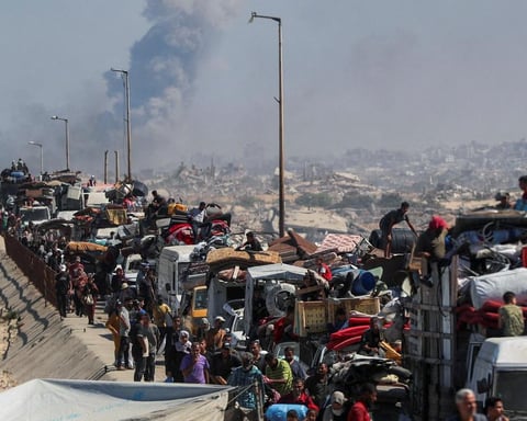Gaza City under Israeli assault as families flee along the al-Rashid coastal road