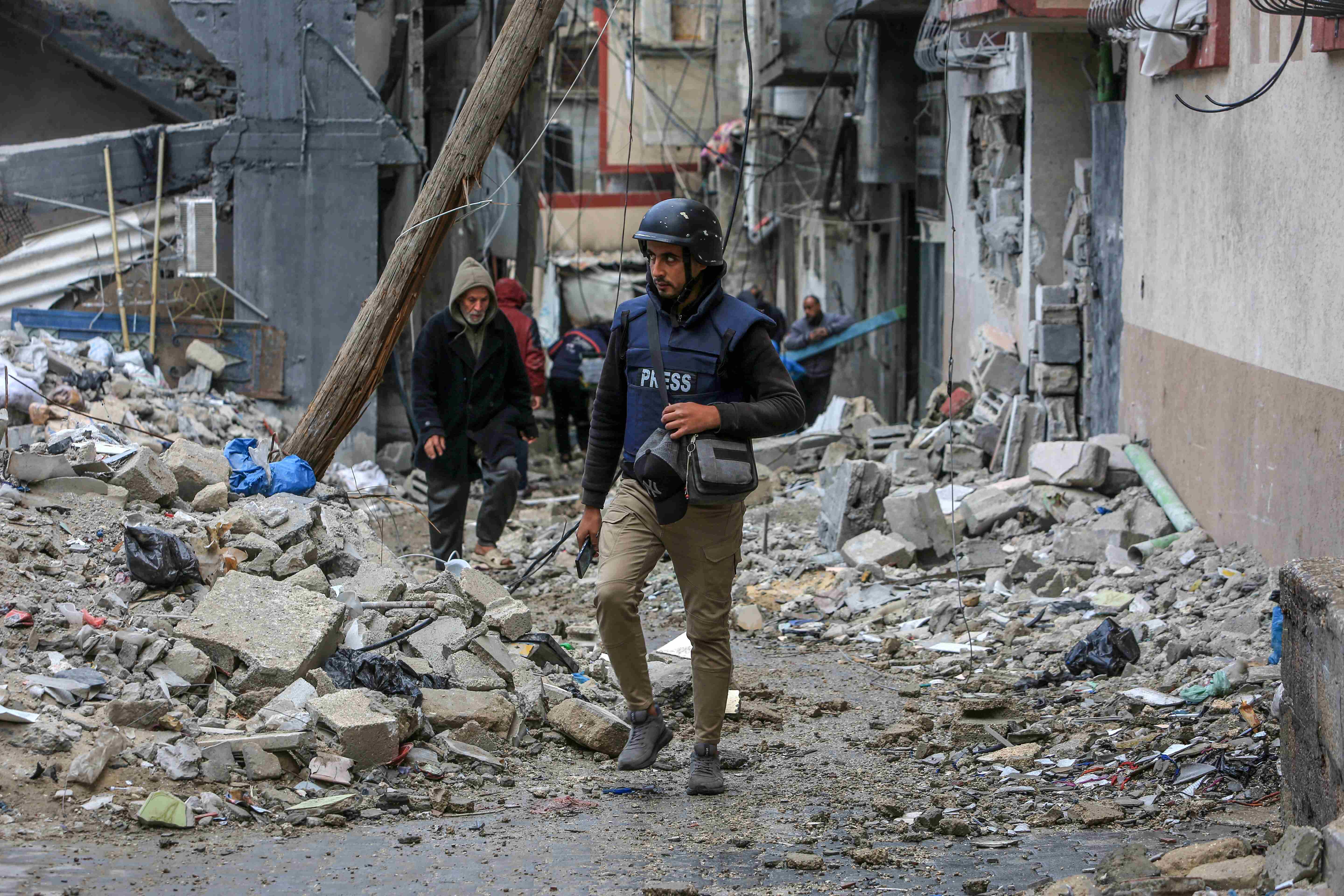 Journalists covering destruction in Gaza city during Israeli bombardment