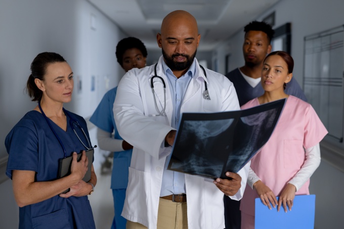 Hospital Staffing At Risk Amid H-1B Fee Clinicians in a U.S. hospital corridor facing staffing challenges
