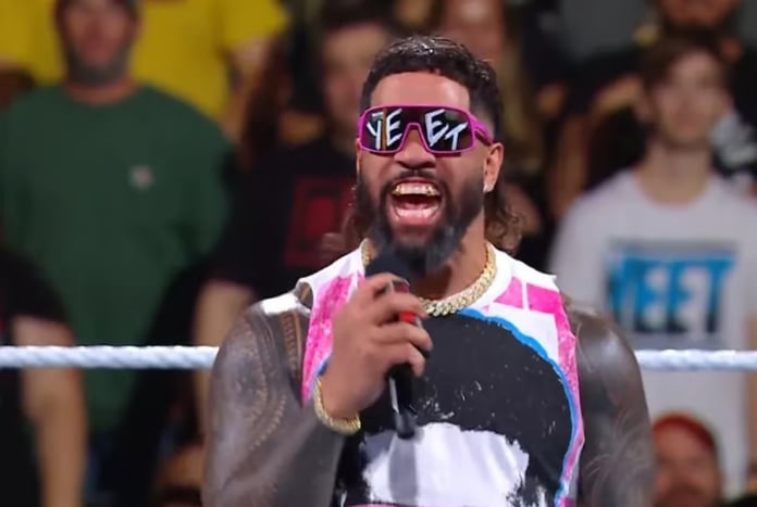 WWE fans wearing Jey Uso Yeet glasses during a live arena event