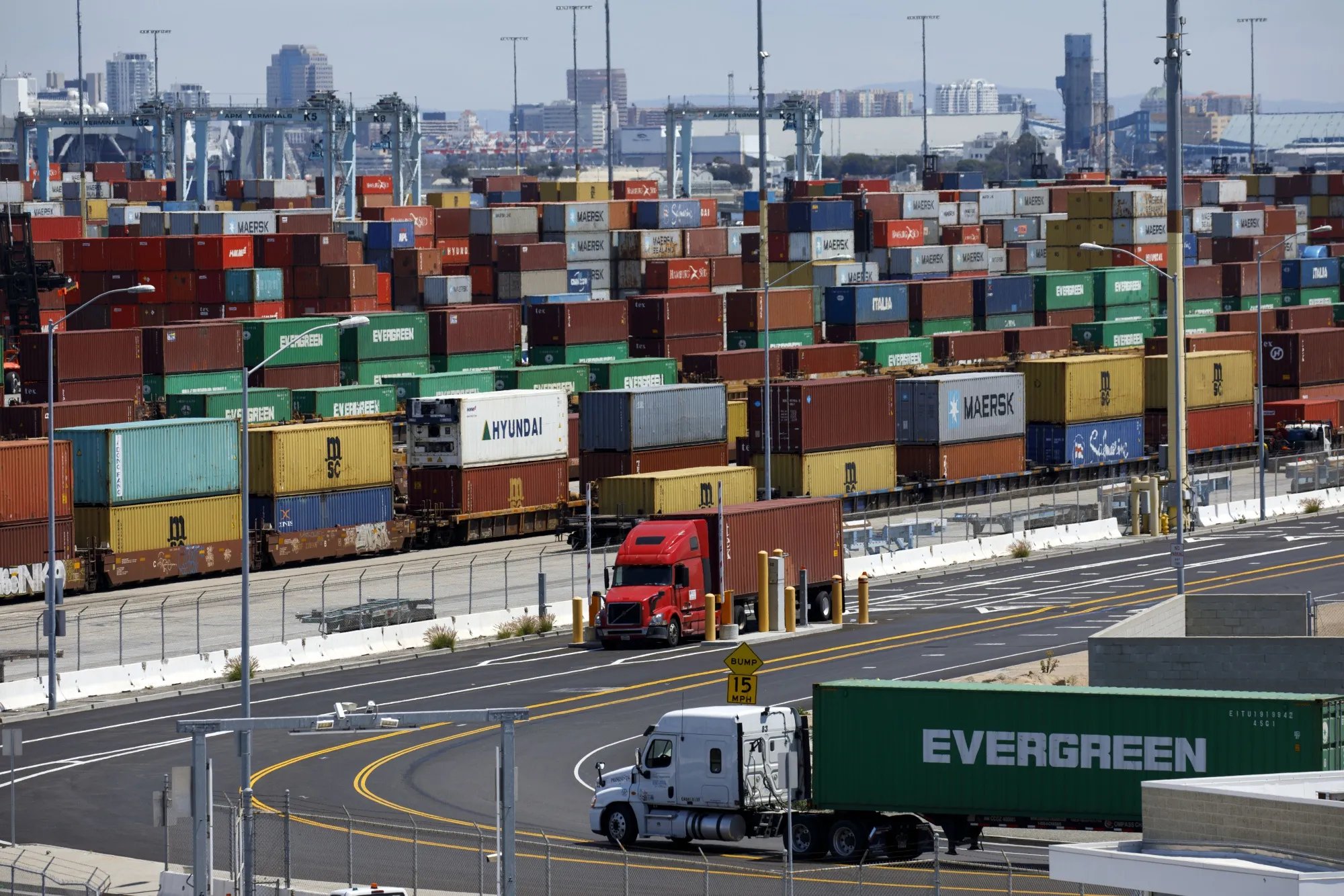 Container trucks at a Southern California port reflecting tariff-driven freight cost pressures