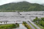 Rescuers survey a destroyed highway bridge in Guangfu, Hualien, after a barrier lake failed during Typhoon Ragasa.