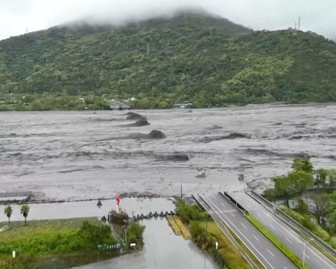 Rescuers survey a destroyed highway bridge in Guangfu, Hualien, after a barrier lake failed during Typhoon Ragasa.