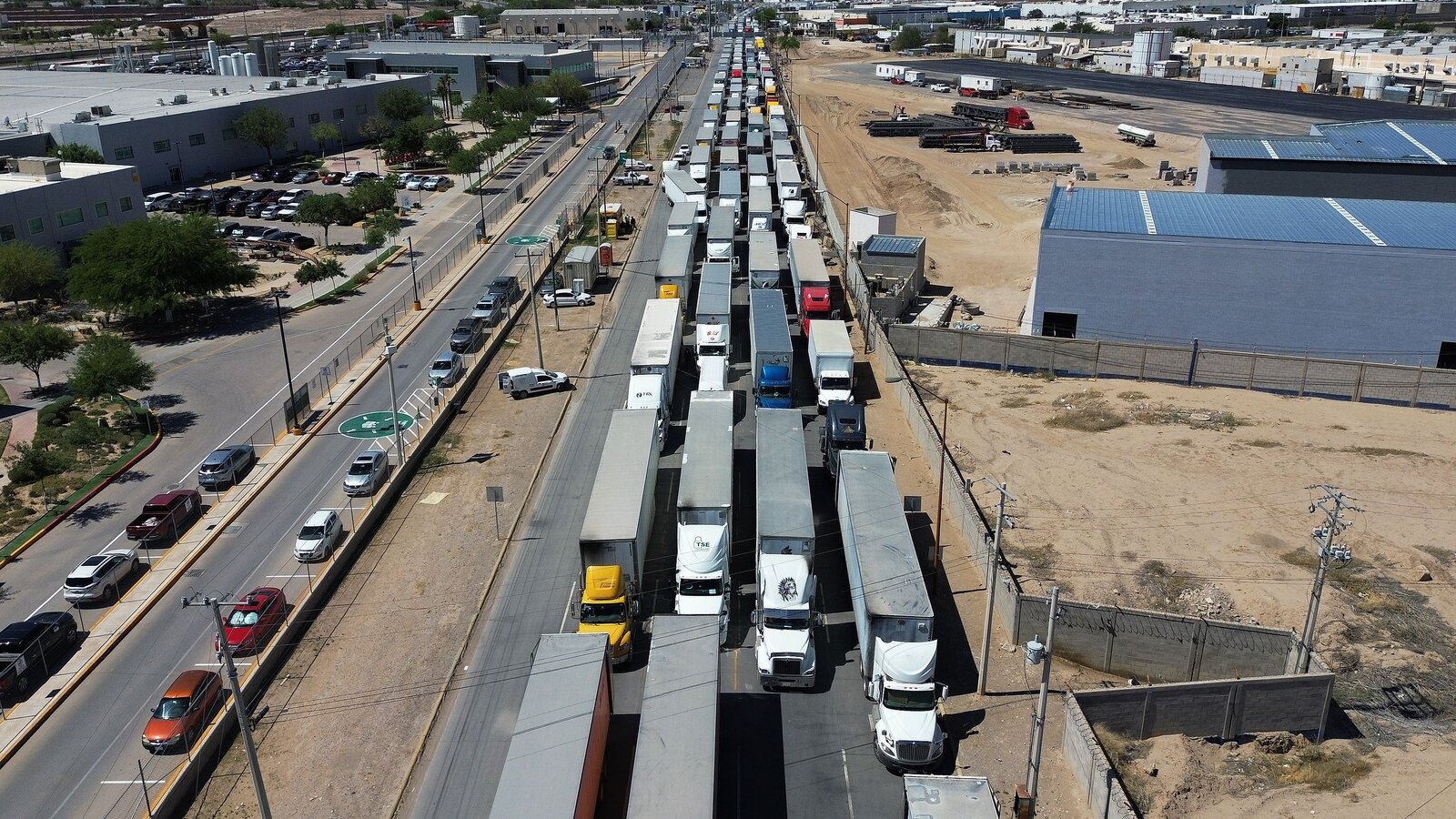 Trucks queue at the US-Mexico World Trade Bridge as a 25 percent tariff on heavy truck imports starts October 1