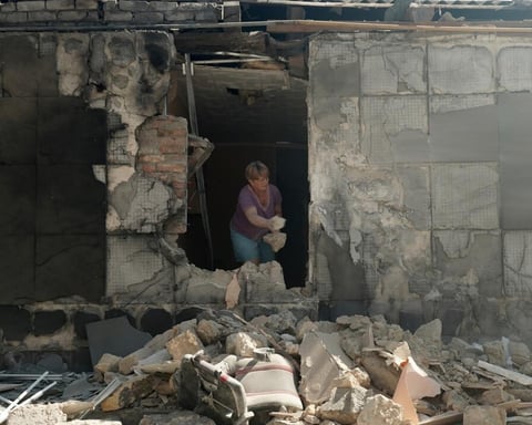Rescue workers in Kherson clear debris after a Russian strike that hit residential blocks on Russia-Ukraine war day 1,311.