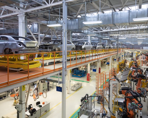 Auto assembly line in northern Mexico with vehicle bodies on conveyor as USMCA trade rules remain in force