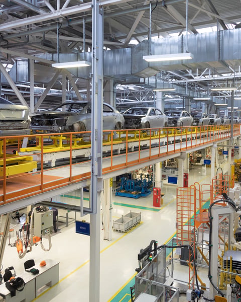 Auto assembly line in northern Mexico with vehicle bodies on conveyor as USMCA trade rules remain in force
