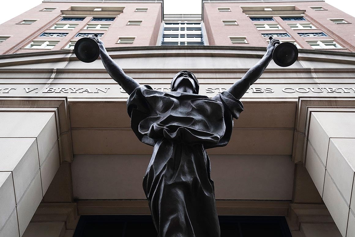 Albert V. Bryan United States Courthouse facade with Justice Delayed statue in Alexandria, Virginia