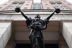 Albert V. Bryan United States Courthouse facade with Justice Delayed statue in Alexandria, Virginia