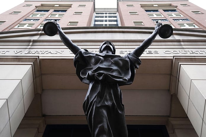 Albert V. Bryan United States Courthouse facade with Justice Delayed statue in Alexandria, Virginia