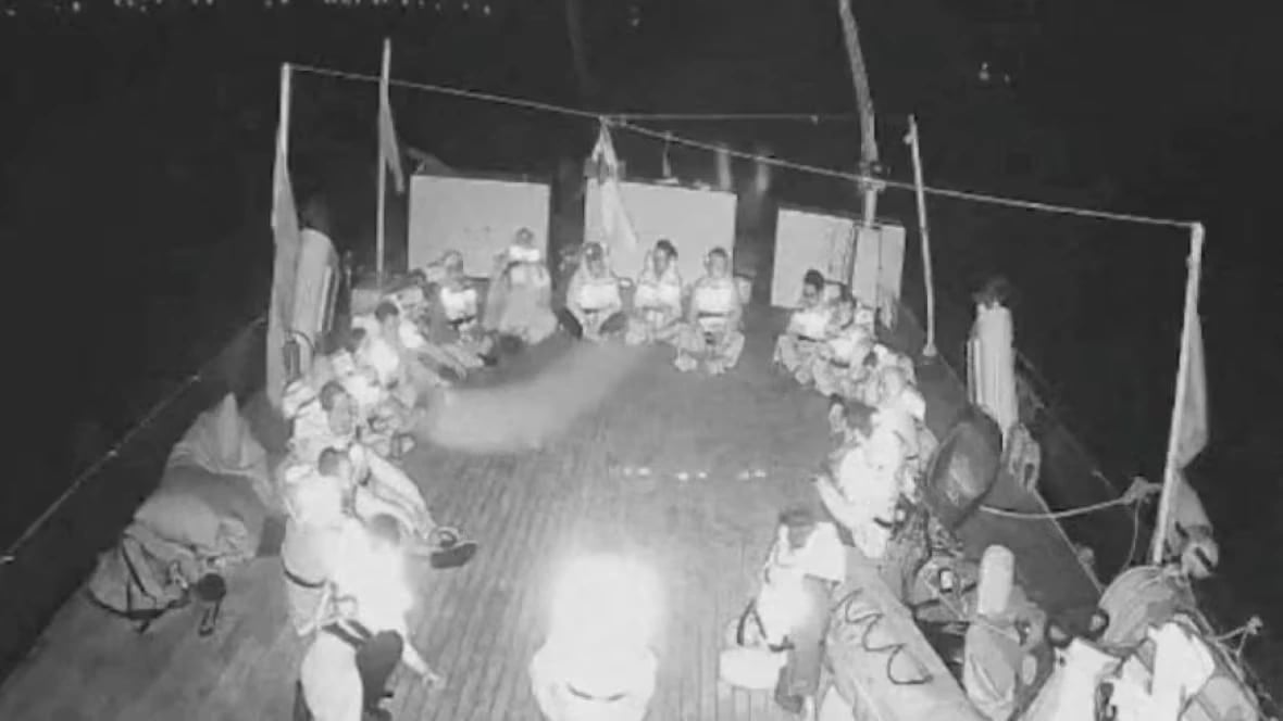 Detained flotilla passengers on deck Detained flotilla passengers seated on deck during transfer to Israeli vessels