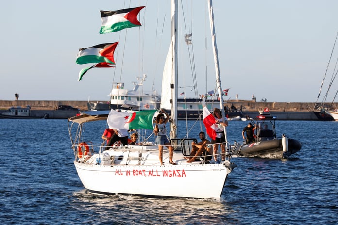 Aid flotilla sailboat with banner en route to Gaza