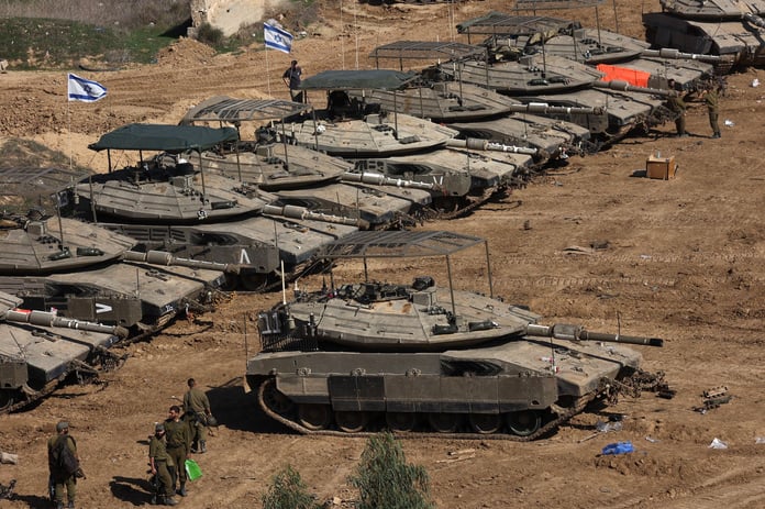 Israeli armored vehicles near the Gaza border as units reposition under the first phase timetable