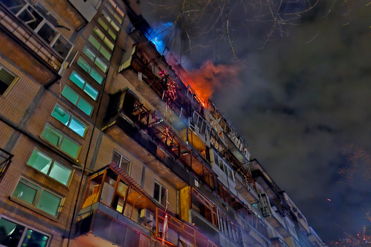 Firefighters evacuate residents from a smoke-filled Kyiv apartment block after a night drone strike.