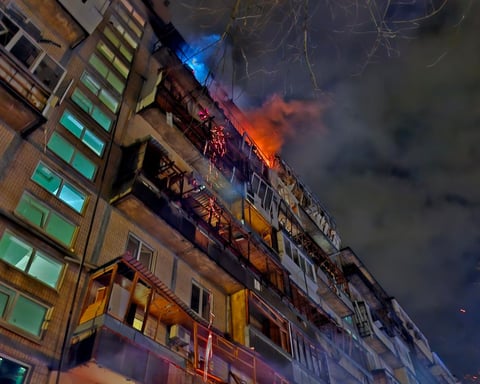 Firefighters evacuate residents from a smoke-filled Kyiv apartment block after a night drone strike.