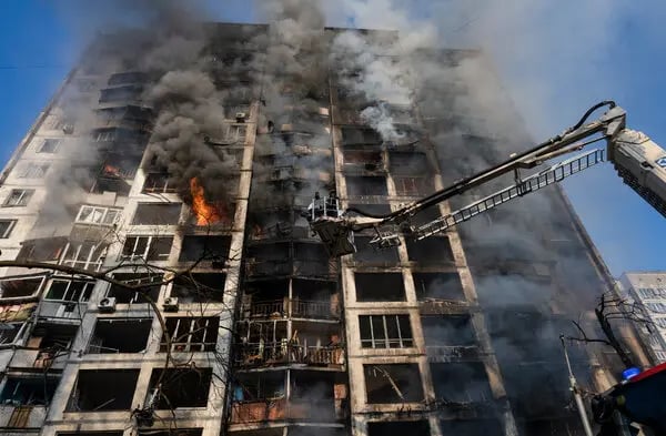 Kyiv Evacuations After Overnight Drone Strike Residents are escorted down ladders from a damaged Kyiv high-rise after a drone strike.