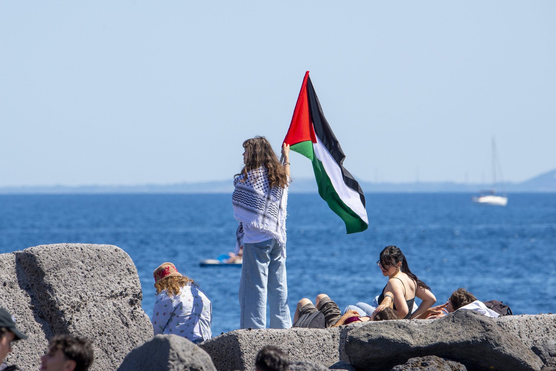 The yacht Madleen with a Palestinian flag on the bow during preparations in Sicily