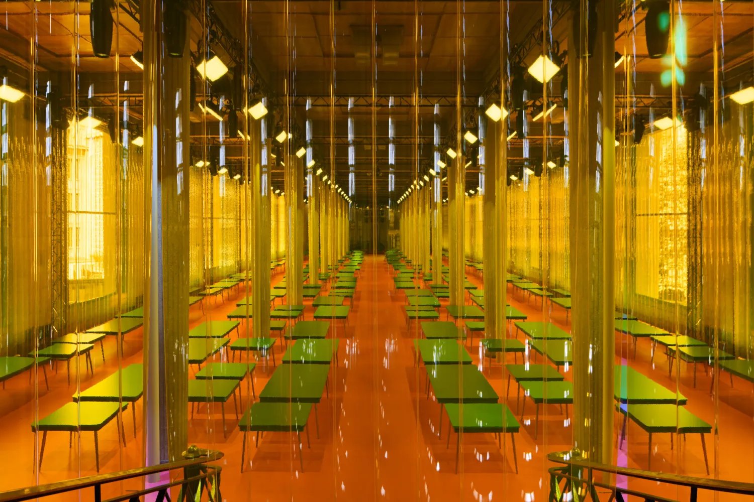 Inside Palais d’Iéna during Miu Miu Spring 2026 with tables across the show space