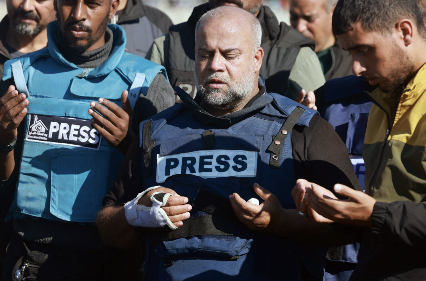 Journalists hold a vigil with press vests and candles