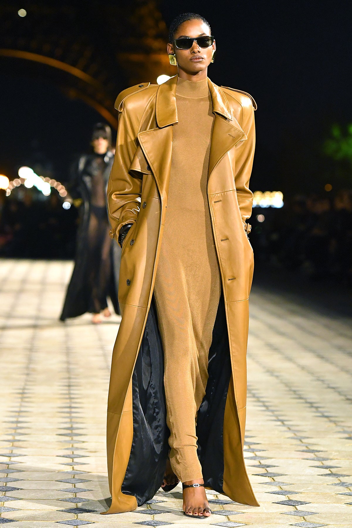 Mustard coatdress in motion — Saint Laurent SS26 Model in mustard coatdress with high belt and black slingbacks at Saint Laurent Spring 2026