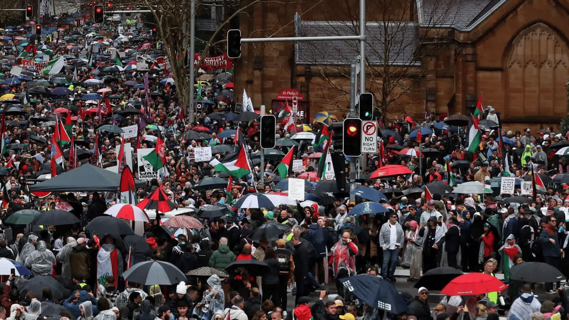 Pro-Palestine protesters stand outside a court building after a ruling on an Opera House march
