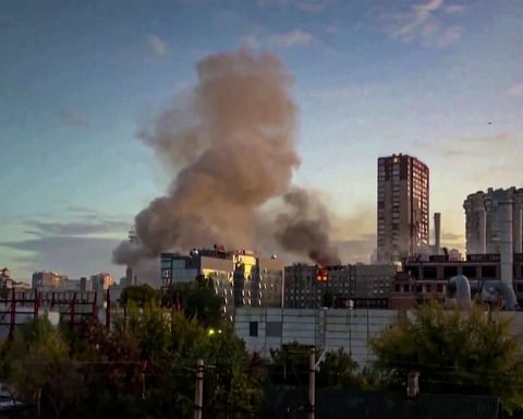 Smoke over Kyiv after an overnight drone and missile barrage that triggered rolling blackouts