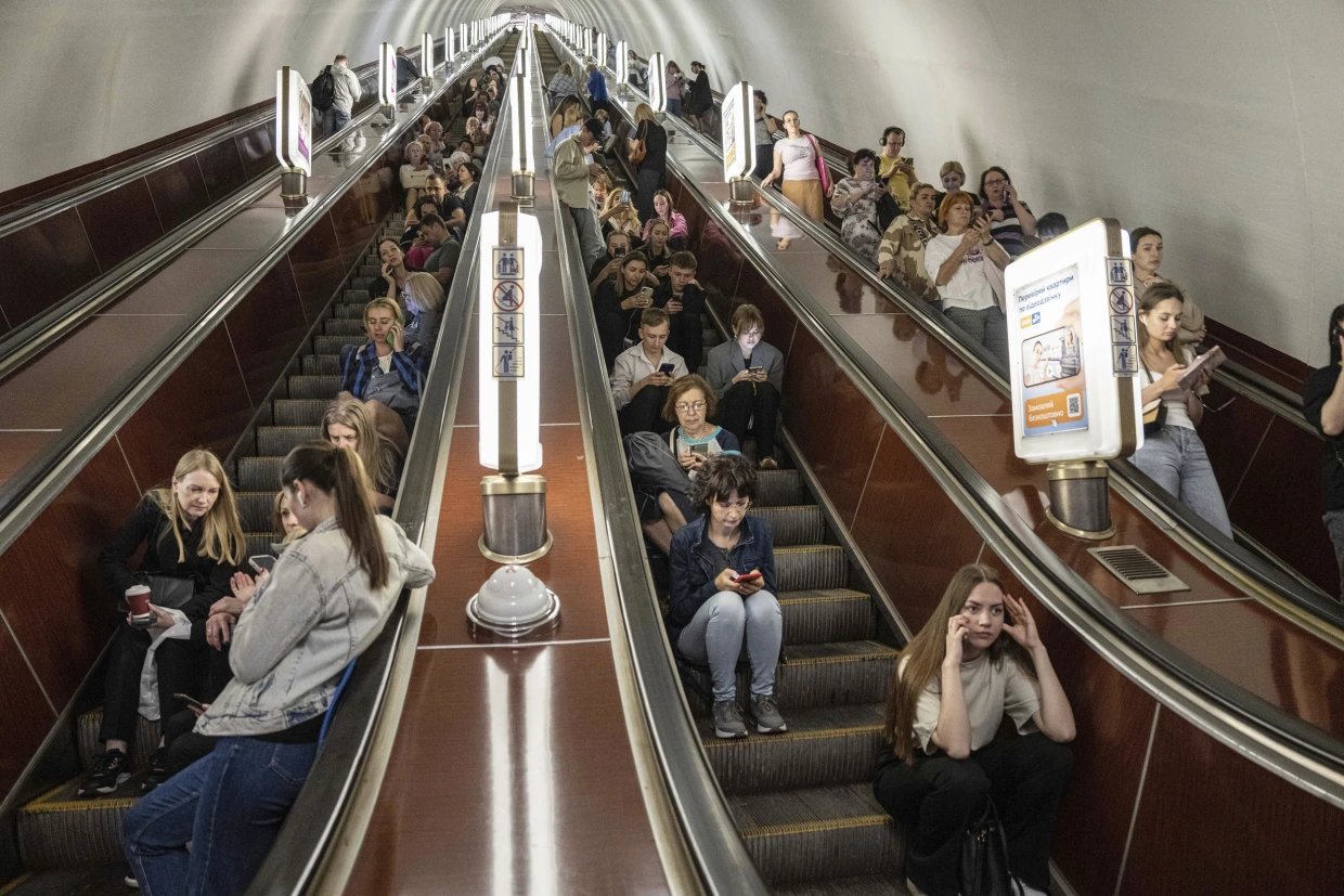 Kyiv adapts to rotating outages Commuters in a dim metro passage in Kyiv during a planned outage window