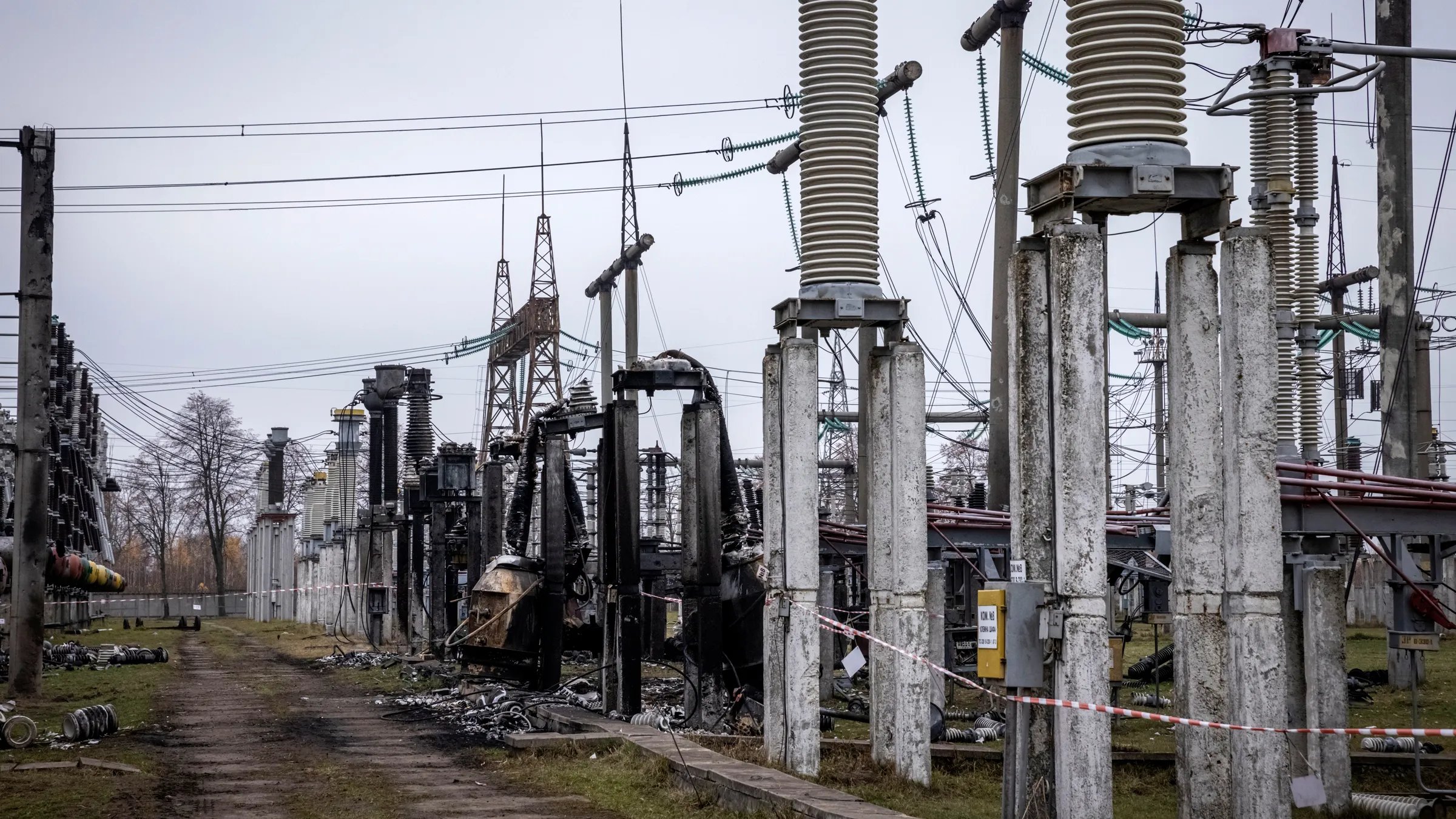 Repair crews assess a burned transformer in Kyiv Ukrenergo technicians assess a burned transformer at a Kyiv substation after strikes