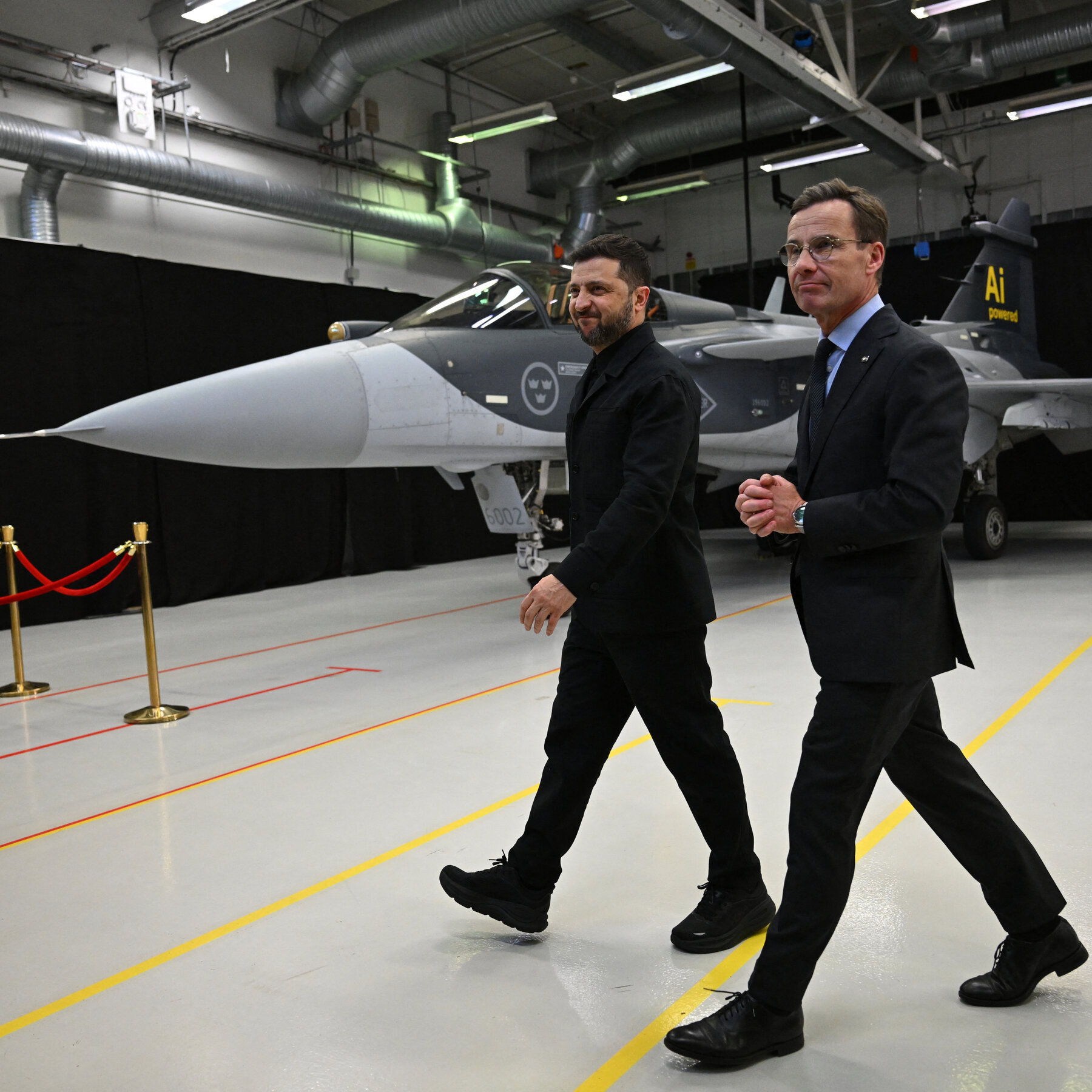 President Volodymyr Zelenskyy stands near a Saab Gripen fighter during a visit to Sweden