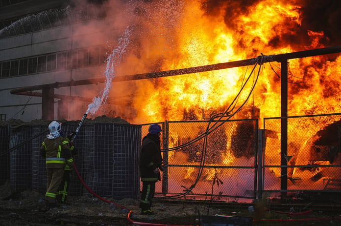 Firefighters work at a damaged power substation after pre-dawn strikes in Ukraine