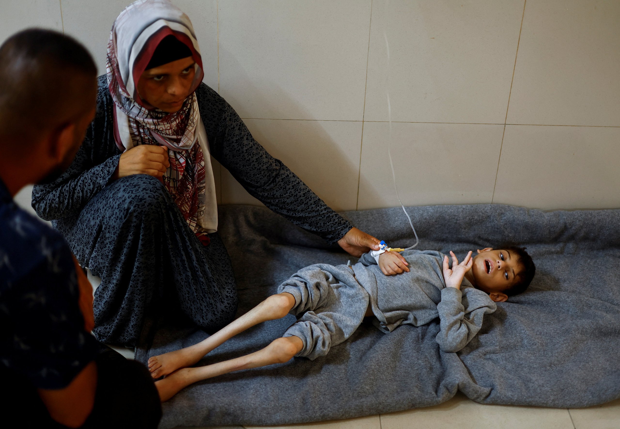 Mothers and babies at a Gaza nutrition clinic receiving ready-to-use therapeutic food