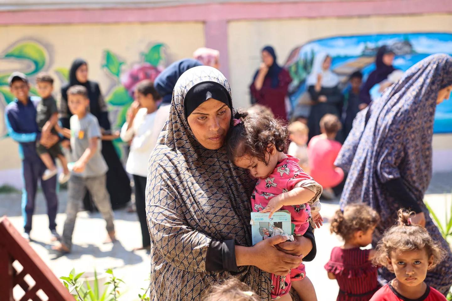 Nutrition screening amid rising malnutrition — UNICEF/El Baba A mother and child wait during a nutrition screening at a UNICEF-supported clinic in the Gaza Strip.