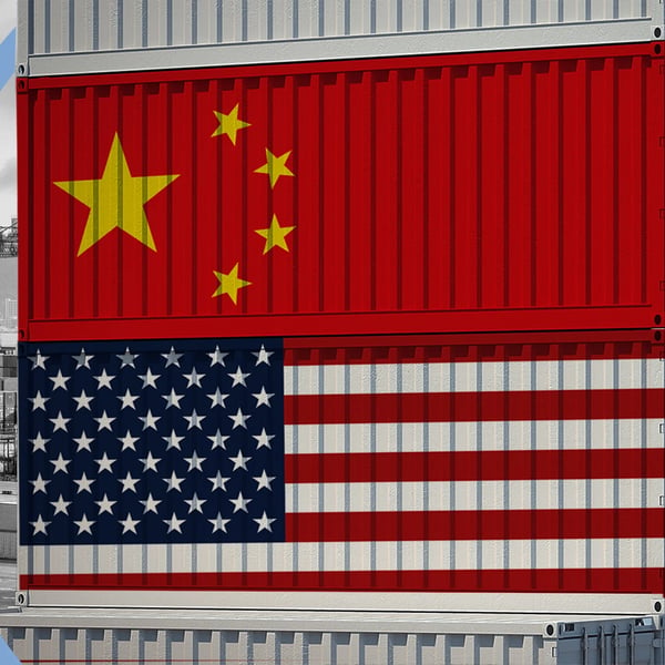 US and China flags over shipping containers at a port