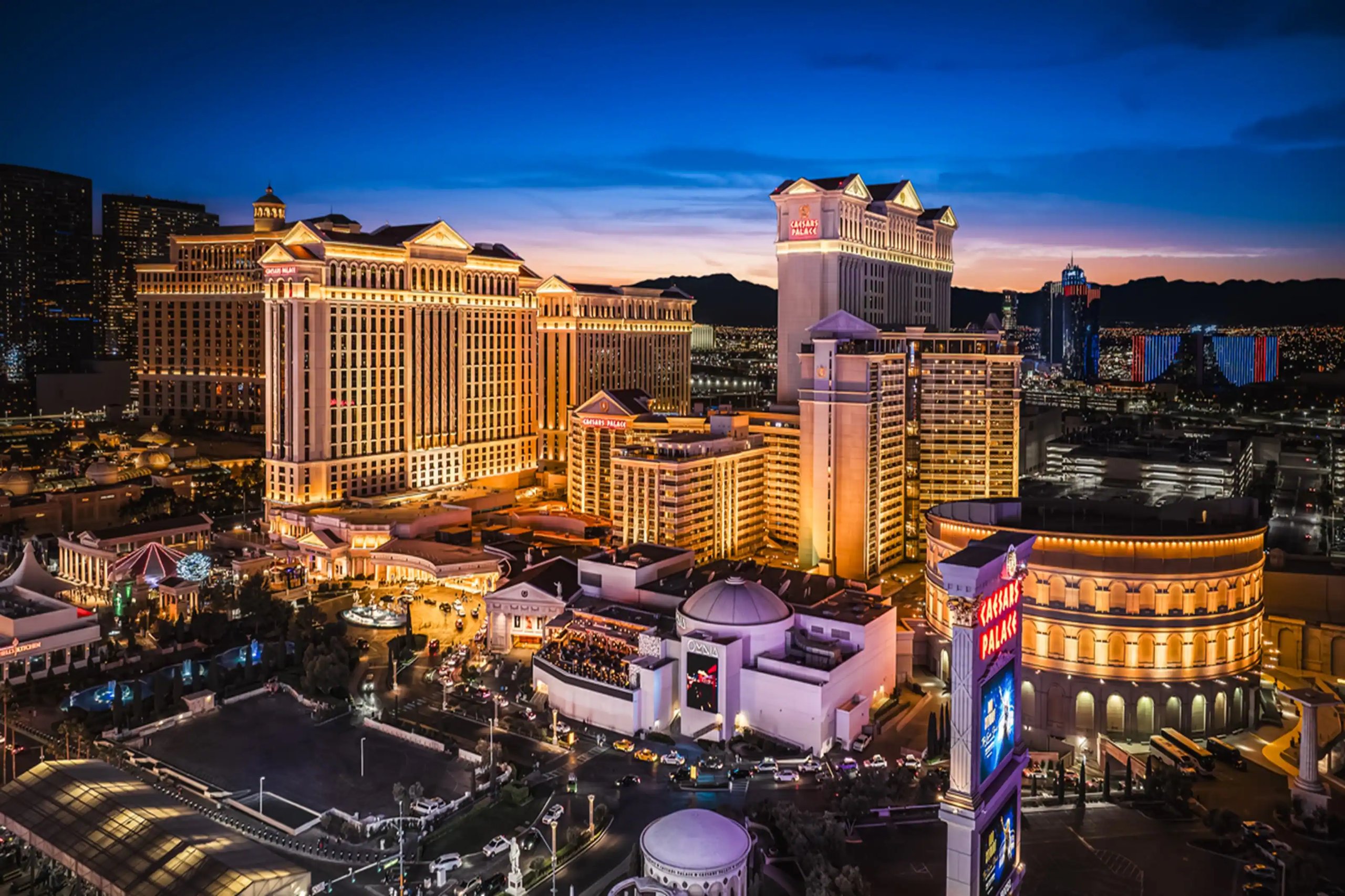 Caesars Palace casino exterior lit up at night, Las Vegas Strip.